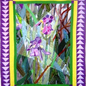 Fractured landscape quilt of two irises on a wooded background framed in a traditional Flying Geese border using purple-hued fabrics