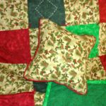 Matching quilt and pillow of Holiday pine trees and berries in red, dark green and light green fabrics