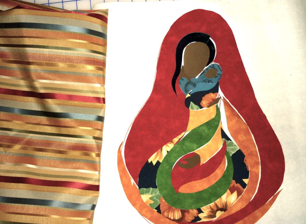 Quilt of a Madonna of colour with child rendered in bright tropical fabrics