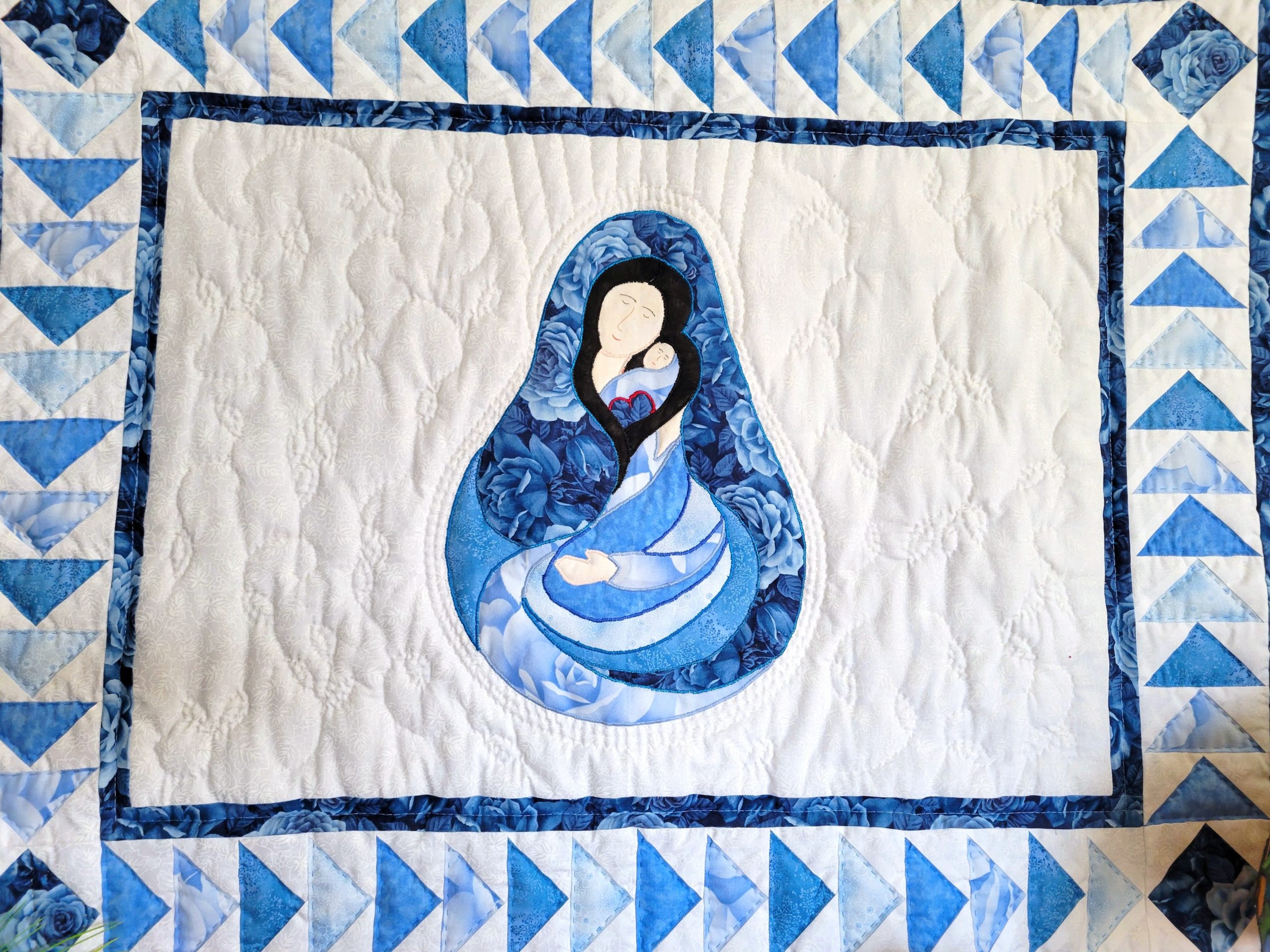 Madonna and Child quilt with traditional Flying Geese border using in blue tonal fabrics