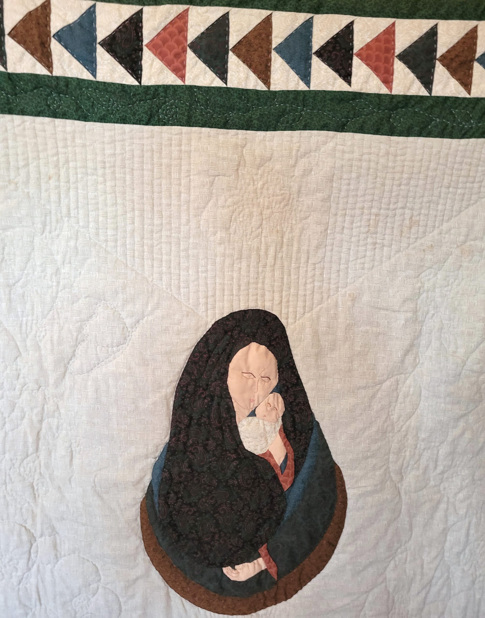 Quilt of Madonna and Child with fine detailed hand-stitching