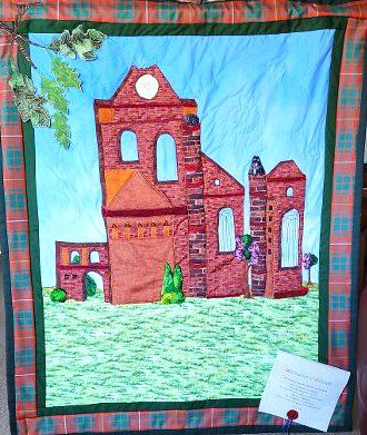 Beautiful quilt of Arbroath Abbey with 3-D aspects framed with the Bruce tartan