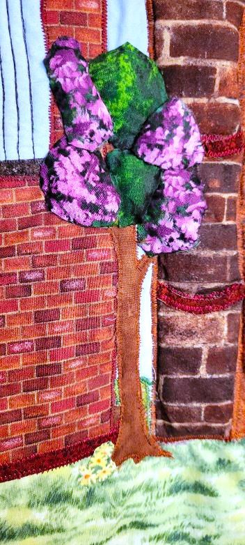 Flowering trees stitched onto a quilt depicting Arbroath Abbey