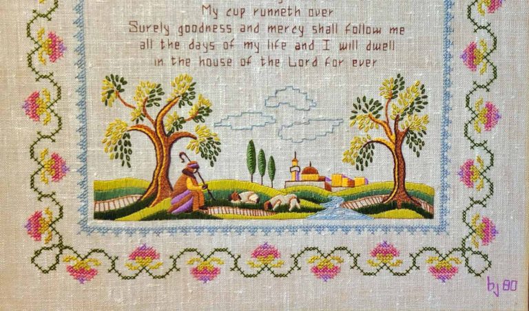 Cross-stitch sampler of the 23rd Psalm with a pink rose border