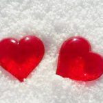 Two red valentines sparkle in a bank of snow