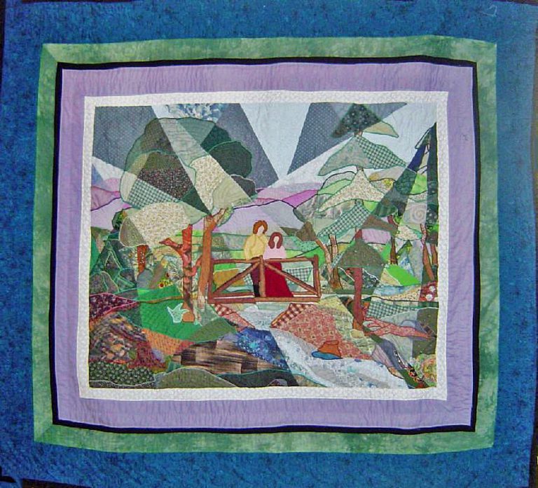 Fractured landscape quilt of a couple on a bridge surrounded by forest trees and stream using a wide array of fabric and multi-coloured threads