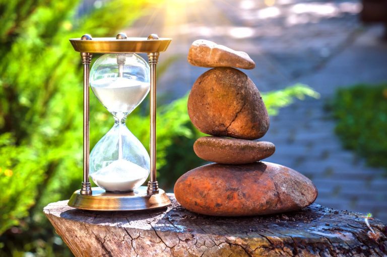 Hourglass and stone cairn