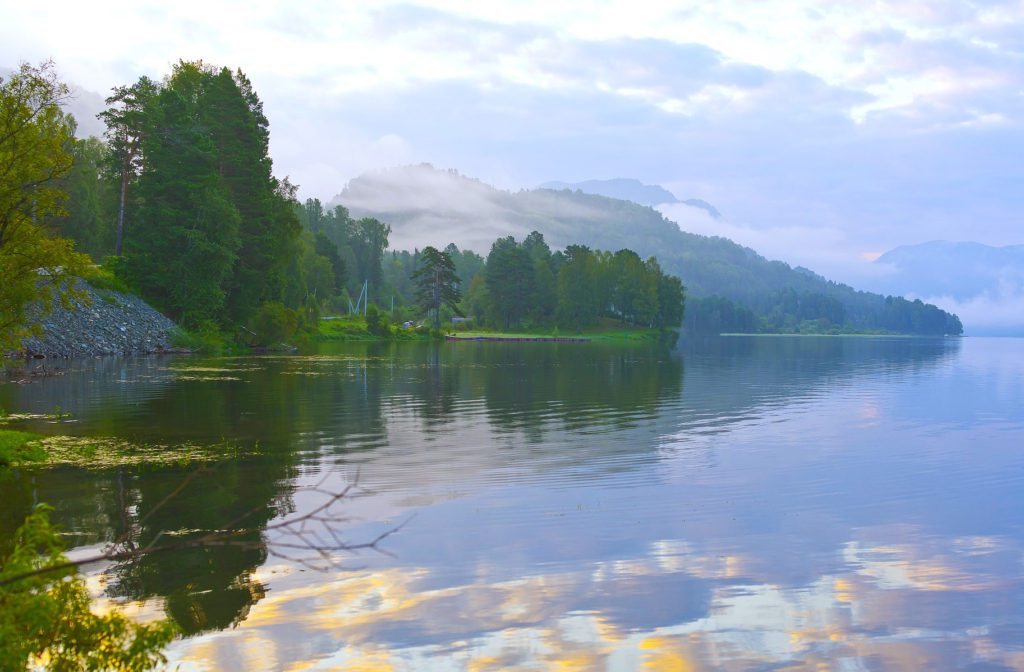 Still waters reflecting a sunny sky