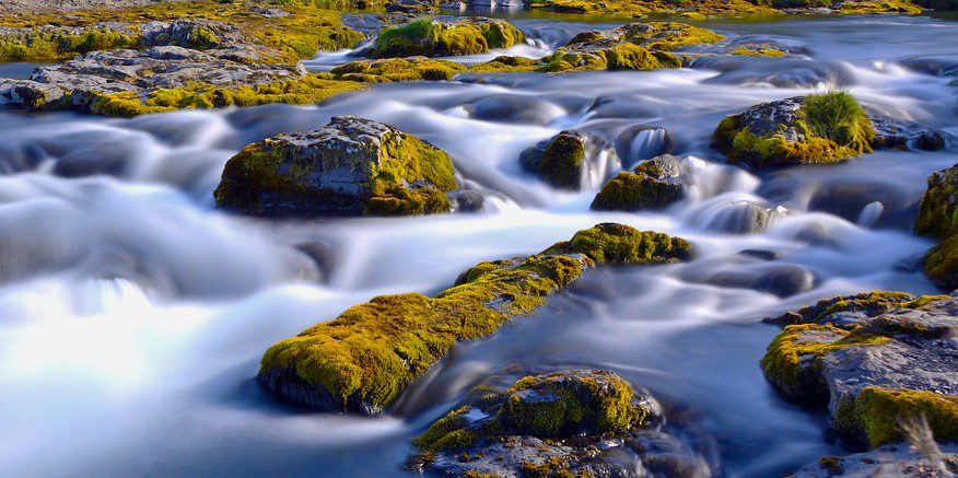 River streaming over moss-covered rocks