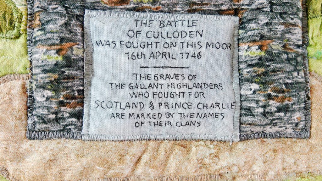 The plaque on the Memorial Cairn at Culloden Battlefield