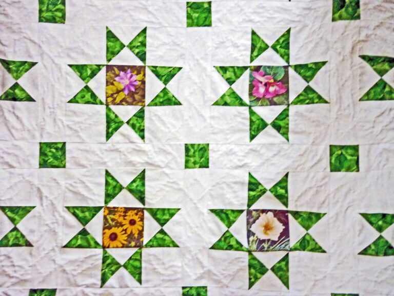 Four Ohio Star quilt blocks with floral center squares