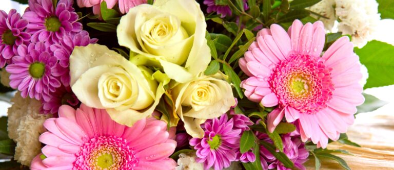 A bouquet of yellow roses and pink daisies