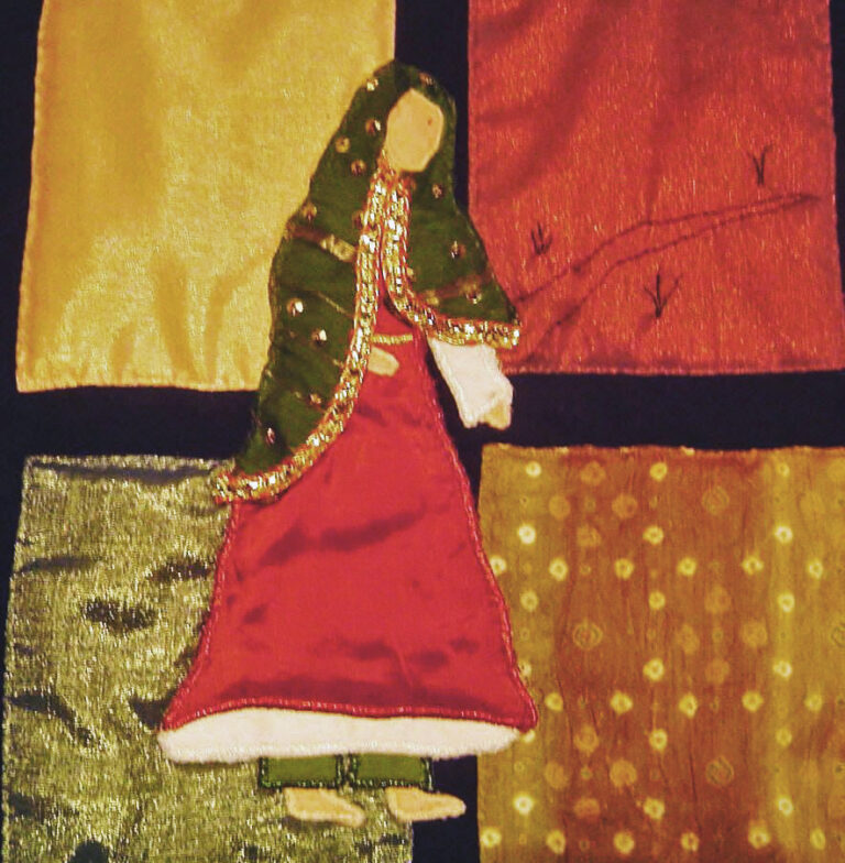 Applique figure of a woman in Indian dress complete with a beaded and sequined sari