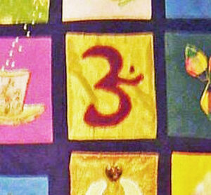 India's Ohm symbol appliqued onto a quilt on bright beautiful colors