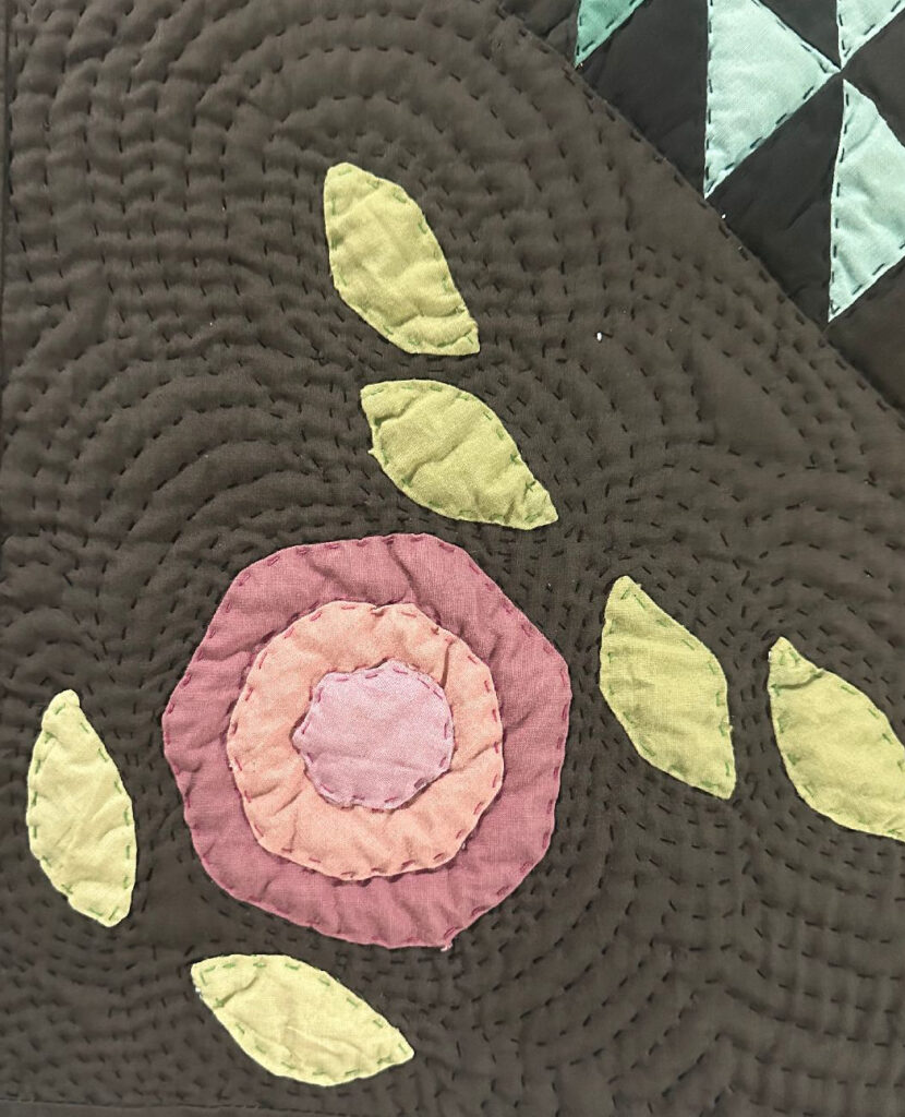 Quilted rose and leaves using a technique known as "echo quilting'.