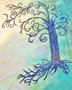 Applique image of the Tree of Life being stitched onto a quilt