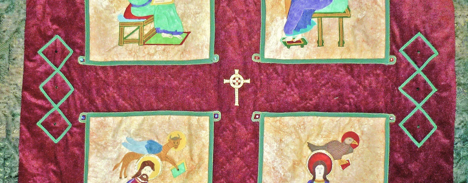 Quilt of the four evangelists from the Lindisfarne Gospels on a burgundy background framed in a Celtic knot design