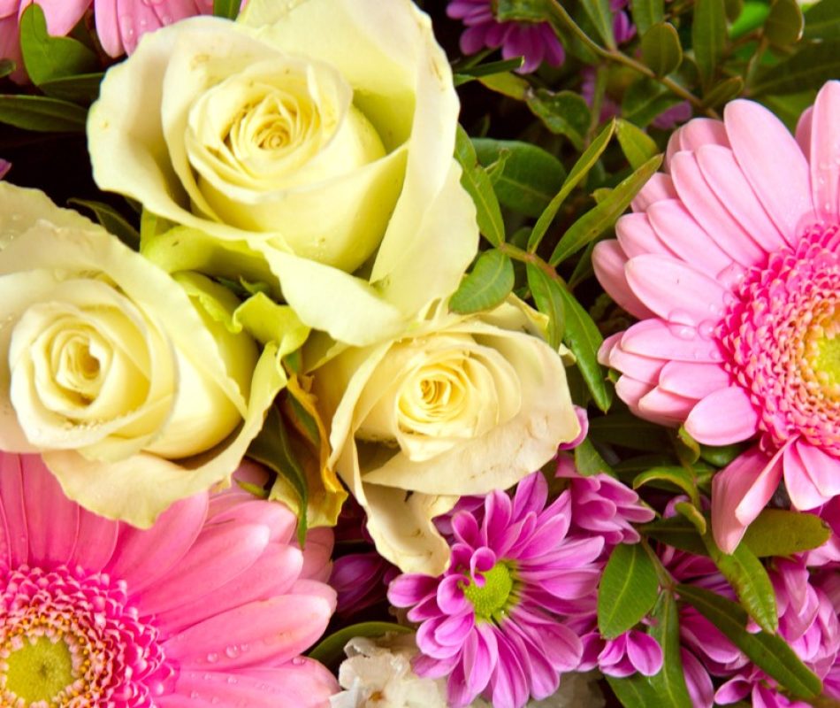 A bouquet of yellow roses and pink daisies