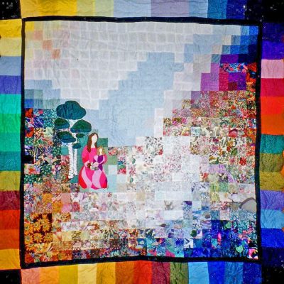 Watercolour quilt of a mother and daughter against a multi hued background of squares