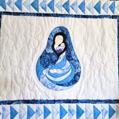 Madonna and Child quilt with traditional Flying Geese border using in blue tonal fabrics