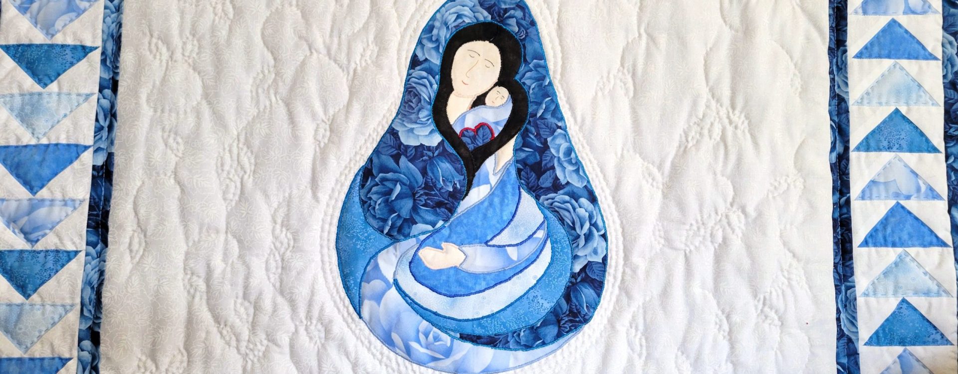 Madonna and Child quilt with traditional Flying Geese border using in blue tonal fabrics