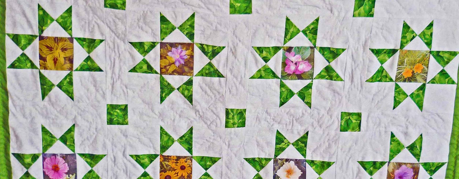 Traditional Ohio Star quilt with 16 stars and flowers sewn into the center of the blocks