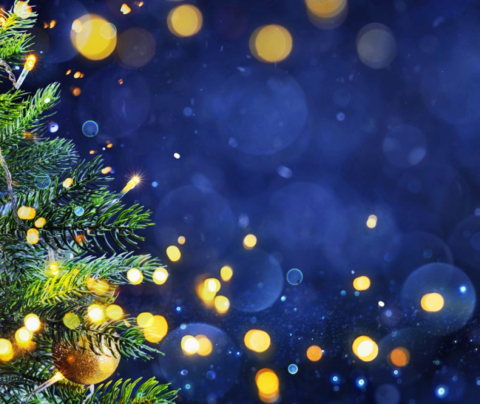 Merry Christmas - Tree In Th Snowy Night With Defocused Lights In Glittering Background